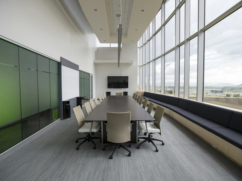 Rectangular brown wooden table with chair lot inside building
