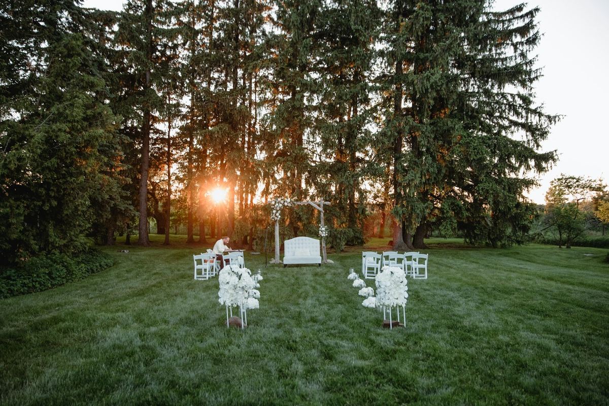 Outdoor wedding ceremony setup with sunset lighting