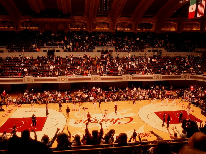 Basketball game in a packed arena with cheering crowd