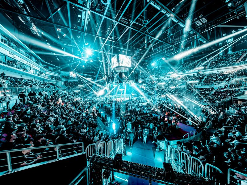 Crowd at a concert with bright blue stage lights