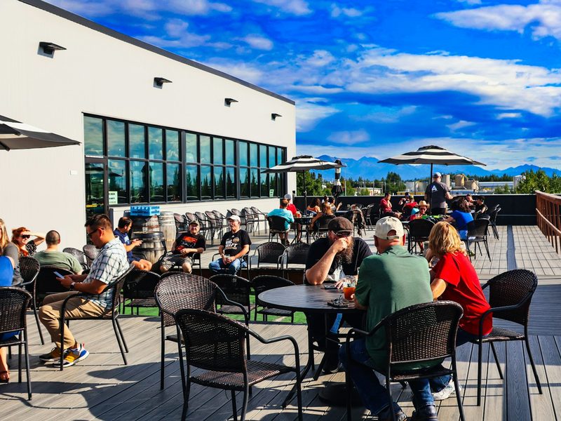 A group of people sitting at tables on top of a roof