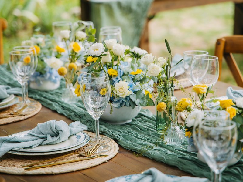 A beautifully set table with floral arrangements for an event