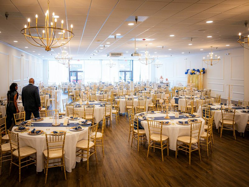 Elegant banquet hall set for an event with round tables