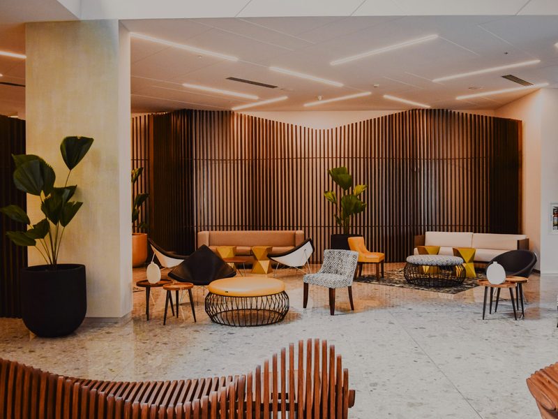 Modern hotel lobby with designer furniture and wood walls