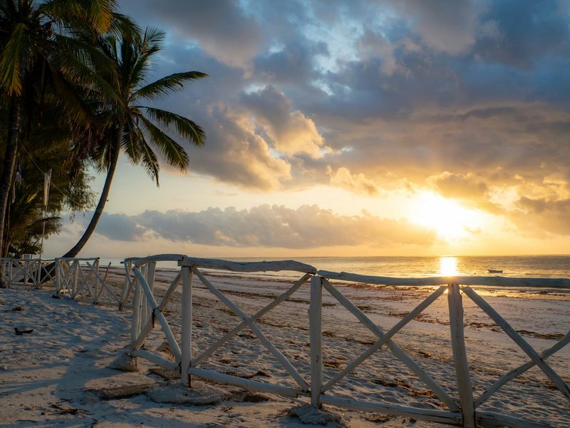 Sunrise over Diani Beach with palm trees