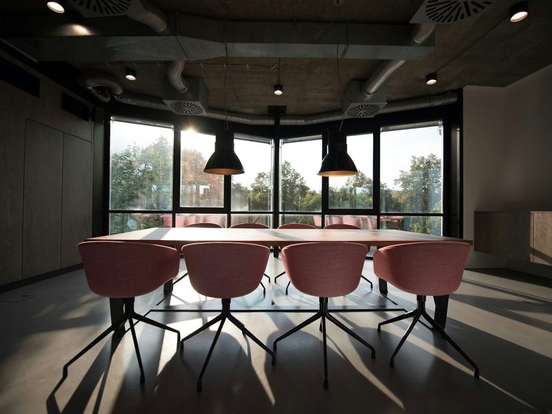 Pink dining table with four chairs inside room