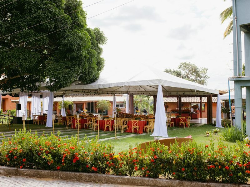Outdoor event tent with tables and chairs on green grass