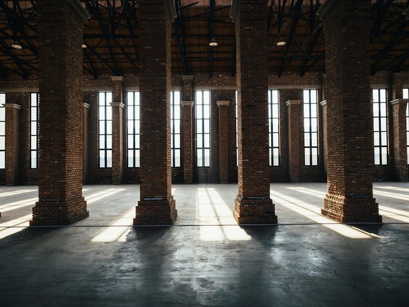 Tall windows and brick columns in a converted warehouse